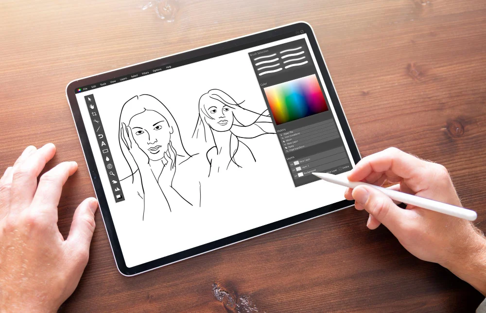 Editorial scene: Hands using a stylus on a tablet for digital drawing; not a product test
